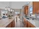 Bright kitchen featuring wood cabinets, stainless steel sink, and quartz countertops under a window at 2914 Lake James Dr, Fuquay Varina, NC 27526