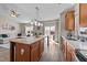 Open kitchen with island and stainless steel appliances, flowing into a living room with natural light at 2914 Lake James Dr, Fuquay Varina, NC 27526