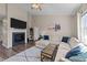 Inviting living room with a fireplace, large sectional sofa, and natural light at 2914 Lake James Dr, Fuquay Varina, NC 27526
