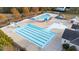 Aerial view of a well-maintained community pool area with various pools, slides, and sun shelters for residents at 2914 Lake James Dr, Fuquay Varina, NC 27526