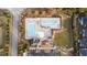 Top-down view of a community pool area with separate swimming and play sections, plus a clubhouse and playground at 2914 Lake James Dr, Fuquay Varina, NC 27526
