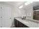 Elegant bathroom with double vanity, granite countertop, and well-lit mirror at 3001 Valleystone Dr, Cary, NC 27519
