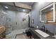 Modern bathroom with sleek gray tiling, a glass-enclosed shower, and stylish vanity at 3001 Valleystone Dr, Cary, NC 27519