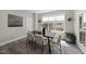 Bright dining room with modern black table set, neutral chairs, and plant accents at 3001 Valleystone Dr, Cary, NC 27519