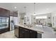 Modern kitchen island with granite countertops and a view to dining area with lots of sunlight at 3001 Valleystone Dr, Cary, NC 27519