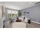Cozy living room with large window, neutral colors, and comfortable seating arrangement at 3001 Valleystone Dr, Cary, NC 27519