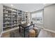 Well-lit home office featuring built-in shelving, modern desk, and comfortable seating at 3001 Valleystone Dr, Cary, NC 27519