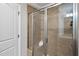 Modern shower with glass door, tiled walls, and built-in shelving at 3001 Valleystone Dr, Cary, NC 27519