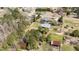 An aerial view of the property, revealing the house, barn, pond, and surrounding trees at 3030 Old Stage S Rd, Erwin, NC 28339