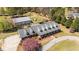 Aerial view of a brick home with a large metal shop, circular driveway, and well-maintained landscaping at 3030 Old Stage S Rd, Erwin, NC 28339