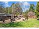 Lush backyard features a charming brick-enclosed sitting area, perfect for outdoor relaxation and entertaining at 3030 Old Stage S Rd, Erwin, NC 28339