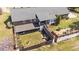 Aerial view of back of home with a fenced backyard, covered patio, and outdoor seating at 3030 Old Stage S Rd, Erwin, NC 28339