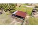 Aerial of barn showing rustic charm, surrounded by green pastures and mature trees at 3030 Old Stage S Rd, Erwin, NC 28339