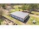 Aerial view of the large barn with multiple garage doors and potential workspace at 3030 Old Stage S Rd, Erwin, NC 28339