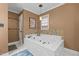 Bright bathroom showcasing a luxurious jetted tub, complemented by neutral tones and a mosaic backsplash at 3030 Old Stage S Rd, Erwin, NC 28339