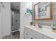 This bathroom features wood-look tile accents, a glass shower and a white vanity with an above counter sink at 3030 Old Stage S Rd, Erwin, NC 28339