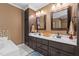 Bathroom featuring a double sink vanity with dark wood cabinets and mosaic tile accents at 3030 Old Stage S Rd, Erwin, NC 28339