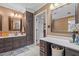Well-lit bathroom with double vanity, dark wood cabinets, and ample counter space for daily routines at 3030 Old Stage S Rd, Erwin, NC 28339