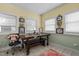 A sunny dining area with a wooden table, a bench, lots of windows and yellow and green walls at 3030 Old Stage S Rd, Erwin, NC 28339