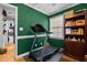Home exercise room featuring a treadmill, a window, and a bookcase for a complete workout space at 3030 Old Stage S Rd, Erwin, NC 28339