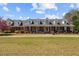 Charming brick home featuring a welcoming front porch,dormers, and beautiful landscaping in a country setting at 3030 Old Stage S Rd, Erwin, NC 28339