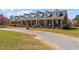 Charming brick home with a welcoming front porch and a gravel driveway in a country setting at 3030 Old Stage S Rd, Erwin, NC 28339