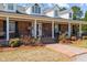 Inviting brick front porch with white columns, seasonal decorations, and a brick walkway at 3030 Old Stage S Rd, Erwin, NC 28339