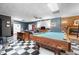 A game room with a pool table, black and white tile floors, a fireplace and a screen at 3030 Old Stage S Rd, Erwin, NC 28339