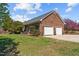 Attached brick garage with two bays and well-maintained landscaping at 3030 Old Stage S Rd, Erwin, NC 28339