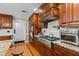 This kitchen features wood cabinets, granite countertops, and stainless steel appliances, perfect for modern living at 3030 Old Stage S Rd, Erwin, NC 28339