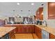Open-concept kitchen with granite countertops and wood cabinets, seamlessly connecting to the dining area at 3030 Old Stage S Rd, Erwin, NC 28339
