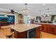 Spacious kitchen with a large granite island, wood cabinets, and modern appliances, great for entertaining at 3030 Old Stage S Rd, Erwin, NC 28339