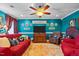 Cozy living room with colorful accents, including a red sofa, patterned rug, and teal walls at 3030 Old Stage S Rd, Erwin, NC 28339