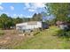 Backyard with outbuilding, gardening plots, and mature trees on a large lot at 3030 Old Stage S Rd, Erwin, NC 28339