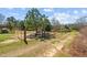 Rural land with a dirt road, fencing, and various outbuildings at 3030 Old Stage S Rd, Erwin, NC 28339