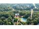 An aerial view featuring the pool and tennis courts nestled among the lush trees at 306 Lochside Dr, Cary, NC 27518