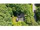 Aerial shot showcasing the home surrounded by dense, mature trees, offering privacy at 306 Lochside Dr, Cary, NC 27518
