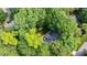 Aerial view of a beautiful home nestled among dense trees, offering serene privacy at 306 Lochside Dr, Cary, NC 27518