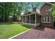 Well-maintained backyard featuring a screened porch, patio, and verdant green lawn at 306 Lochside Dr, Cary, NC 27518