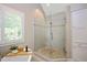 Beautiful bathroom featuring a walk-in glass shower with a tiled surround and a soaking tub at 306 Lochside Dr, Cary, NC 27518