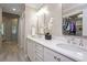 Elegant bathroom with double sinks, white cabinets, marble countertops, and a walk-in shower at 306 Lochside Dr, Cary, NC 27518