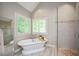 Luxurious bathroom with soaking tub, walk-in shower, and large windows offering plenty of natural light at 306 Lochside Dr, Cary, NC 27518