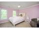 Bedroom with pink walls, a ceiling fan, and a queen-sized bed with ample natural light at 306 Lochside Dr, Cary, NC 27518