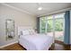 Cozy bedroom with large windows, natural light, and hardwood floors at 306 Lochside Dr, Cary, NC 27518
