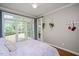 Bright bedroom featuring a ceiling fan, natural light from a large window and stylish decor at 306 Lochside Dr, Cary, NC 27518