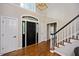 Bright foyer featuring hardwood floors, staircase, and views into the living spaces at 306 Lochside Dr, Cary, NC 27518