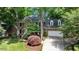 Charming brick home with a two-car garage, manicured lawn, and mature trees at 306 Lochside Dr, Cary, NC 27518