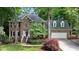 Charming brick home with a two-car garage, manicured lawn, and mature trees at 306 Lochside Dr, Cary, NC 27518