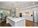 Sun-filled kitchen with island, stainless steel appliances, and eat-in area at 306 Lochside Dr, Cary, NC 27518