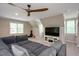Cozy living room featuring a large sectional sofa, TV, and a ceiling fan at 306 Lochside Dr, Cary, NC 27518